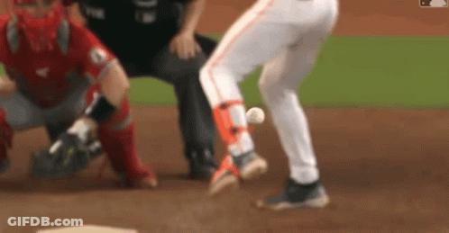 A Blurred Image Of A Baseball Game With A Catcher And Umpire GIF