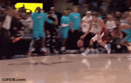A Blurred Image Of A Basketball Game With A Crowd In The Stands GIF