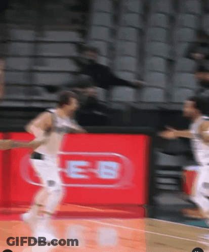 A Blurred Image Of A Basketball Game With A Red Sign That Says Es GIF