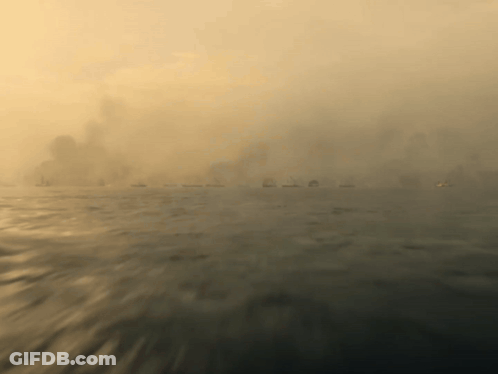 A Blurred Image Of A Body Of Water With A City In The Background GIF