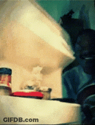 A Blurred Image Of A Bottle With A Red Cap GIF