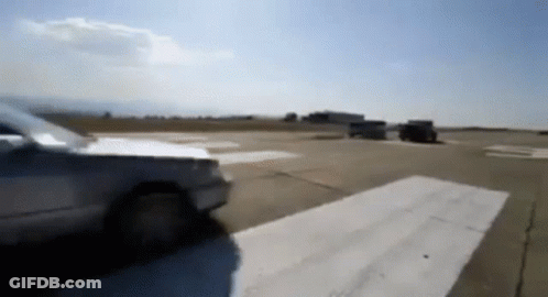A Blurred Image Of A Car Driving Down A Runway GIF
