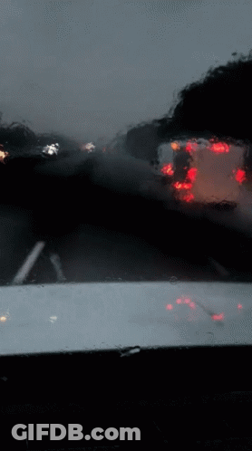 A Blurred Image Of A Car 'S Windshield With Red Lights Reflected In It GIF