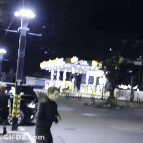 A Blurred Image Of A Carnival At Night With A Carousel In The Background GIF