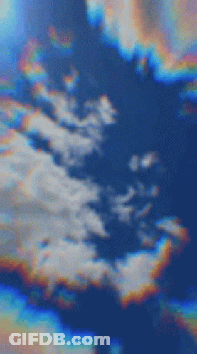 A Blurred Image Of A Cloudy Sky With A Rainbow In The Middle . GIF