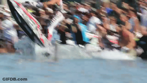 A Blurred Image Of A Crowd Of People Watching A Person On A Surfboard In The Water GIF