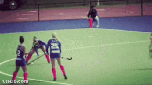 A Blurred Image Of A Field Hockey Game With A Player Wearing A Number 2 Jersey GIF