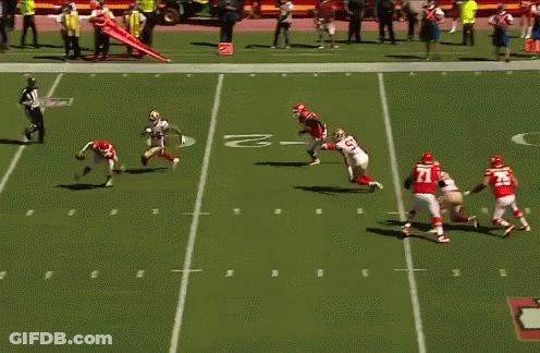 A Blurred Image Of A Football Game With A Player Wearing A Red Jersey That Says ' Washington ' On It GIF