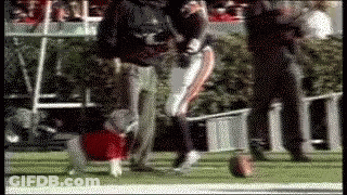 A Blurred Image Of A Football Player Kicking A Ball On The Field GIF
