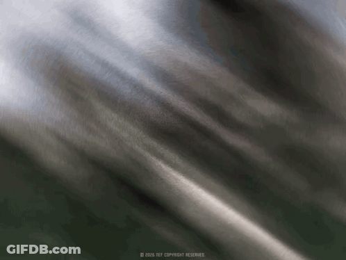A Blurred Image Of A Gray Cloth With A Copyright Watermark GIF
