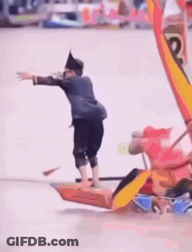 A Blurred Image Of A Group Of People In A Boat That Says ' Coca Cola ' On The Side Of It GIF