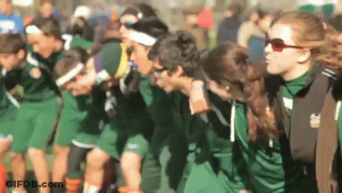 A Blurred Image Of A Group Of People Wearing Green Shirts With The Number 7 On The Front GIF