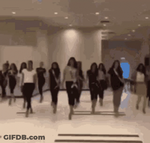 A Blurred Image Of A Group Of Women Dancing In A Room GIF
