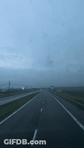 A Blurred Image Of A Highway With A Blue Sky GIF