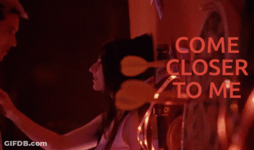 A Blurred Image Of A Man And Woman With The Words Come Closer To Me In Red GIF