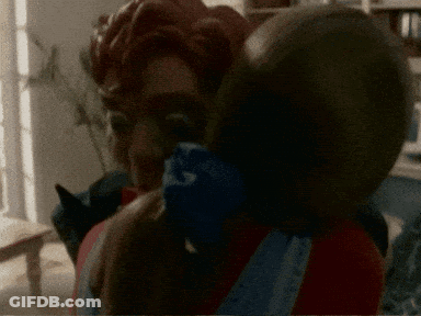 A Blurred Image Of A Man Holding A Child With A Bandana That Says ' A ' On It GIF