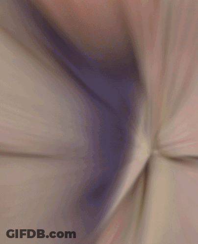 A Blurred Image Of A Man In A Striped Jacket GIF