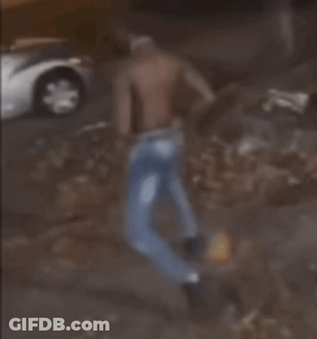 A Blurred Image Of A Man Standing In Front Of A Car GIF