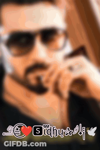 A Blurred Image Of A Man Wearing Sunglasses With The Name Sidhu On It GIF