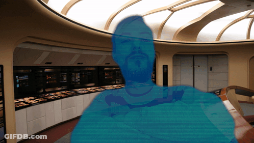 A Blurred Image Of A Man With A Beard In A Room With A Sign That Says ' A ' On It GIF
