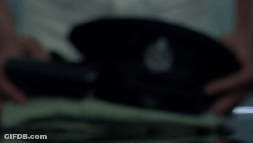 A Blurred Image Of A Person Holding A Black Object In Their Hands GIF