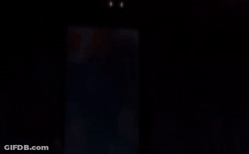 A Blurred Image Of A Person In A Dark Room GIF