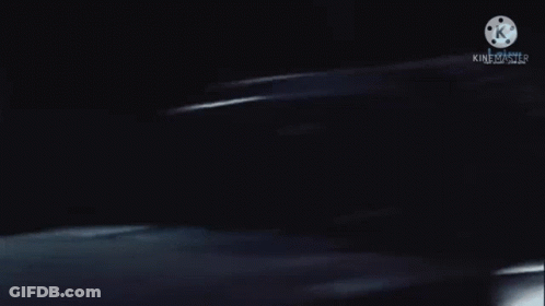 A Blurred Image Of A Person In A Dark Room With A K On The Bottom GIF