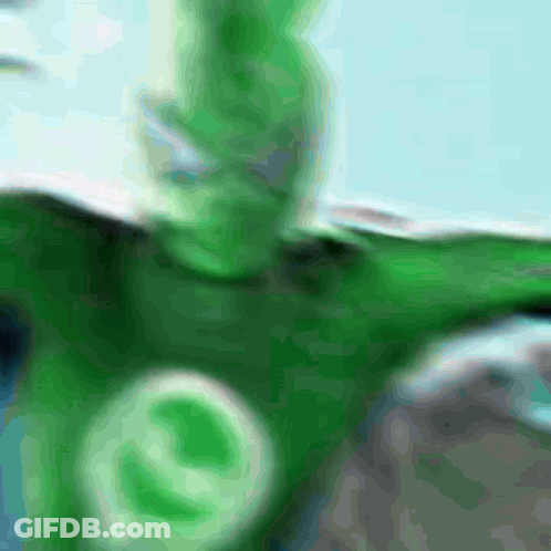 A Blurred Image Of A Person In A Green Costume GIF