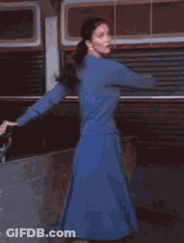 A Blurred Image Of A Person In A Red Shirt And Blue Jeans GIF