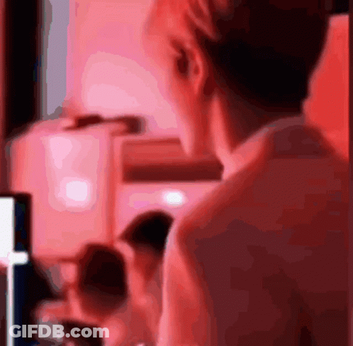 A Blurred Image Of A Person 'S Back With A Red Background GIF