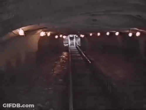 A Blurred Image Of A Person 'S Face With A Few Lights In The Background . GIF