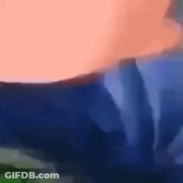 A Blurred Image Of A Person 'S Torso With A Blue Background GIF