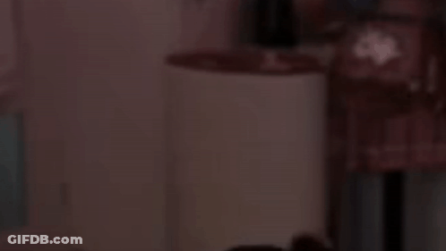 A Blurred Image Of A Person Standing In A Dark Room Holding A Umbrella . GIF