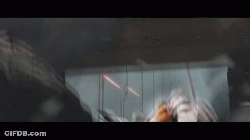 A Blurred Image Of A Person Standing In A Dark Room With A Sword . GIF