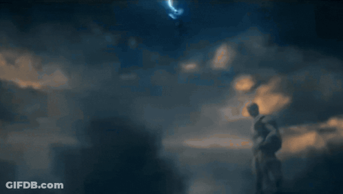 A Blurred Image Of A Person Standing In Front Of A Blue Background GIF