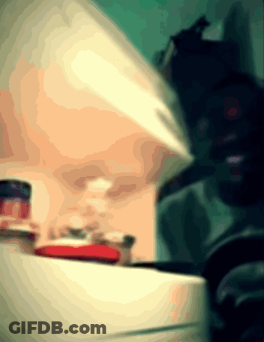 A Blurred Image Of A Person Standing In Front Of A Counter GIF