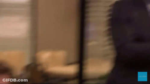 A Blurred Image Of A Person Standing In Front Of A Sign That Says " Be The One " GIF