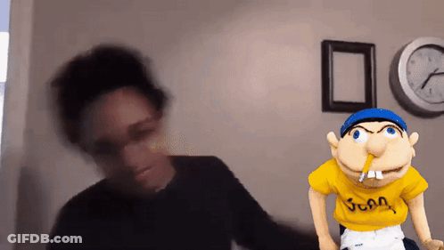 A Blurred Image Of A Person Standing Next To A Puppet With A Yellow Shirt That Says Juan GIF