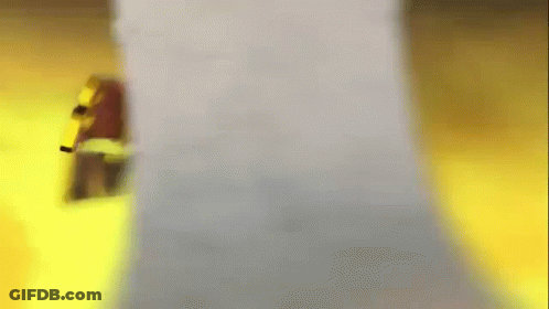 A Blurred Image Of A Person Standing Next To A White Object . GIF