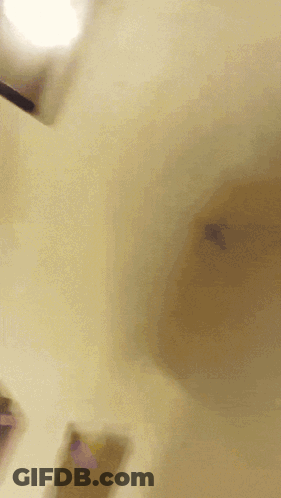 A Blurred Image Of A Person Wearing A Yellow Hat GIF