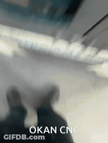 A Blurred Image Of A Person With The Words Okan Cnc Written Below Them GIF