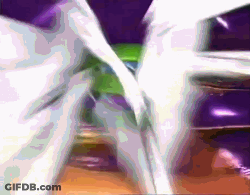 A Blurred Image Of A Purple And Green Colored Object GIF