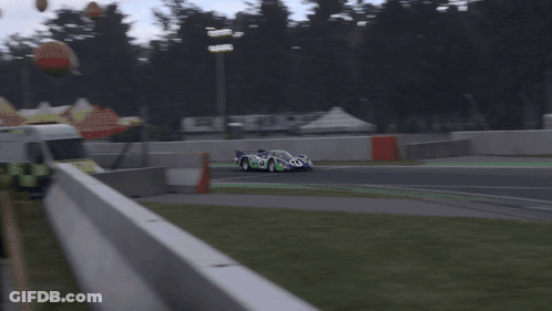 A Blurred Image Of A Race Car On A Track With A Sign That Says ' Heineken ' On It GIF