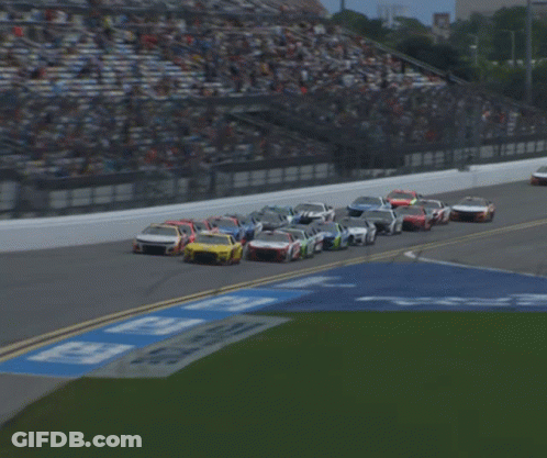 A Blurred Image Of A Race Track With A Sign That Says ' Georgia ' GIF