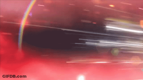 A Blurred Image Of A Red Background With A Rainbow In The Middle GIF