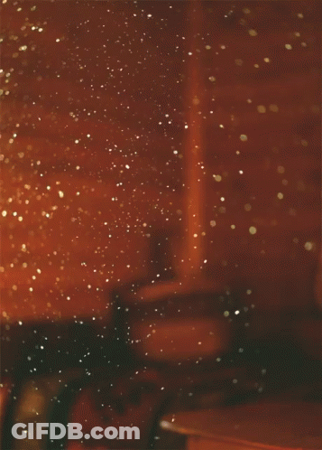 A Blurred Image Of A Room With A Few Lights On The Wall GIF