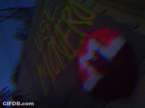 A Blurred Image Of A Sign That Says ' No Parking ' GIF
