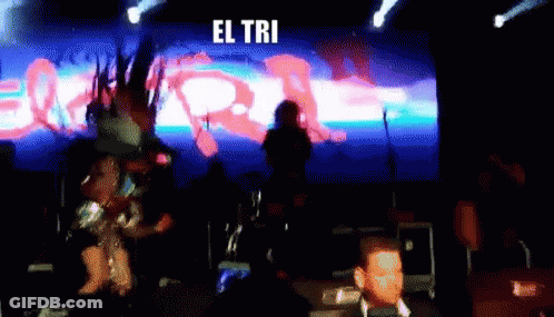 A Blurred Image Of A Stage With The Words El Tri Written On It GIF
