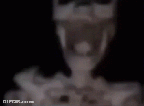 A Blurred Image Of A Table With A Lamp And A Vase On It . GIF