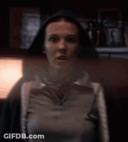 A Blurred Image Of A Woman Walking In Front Of A Car GIF